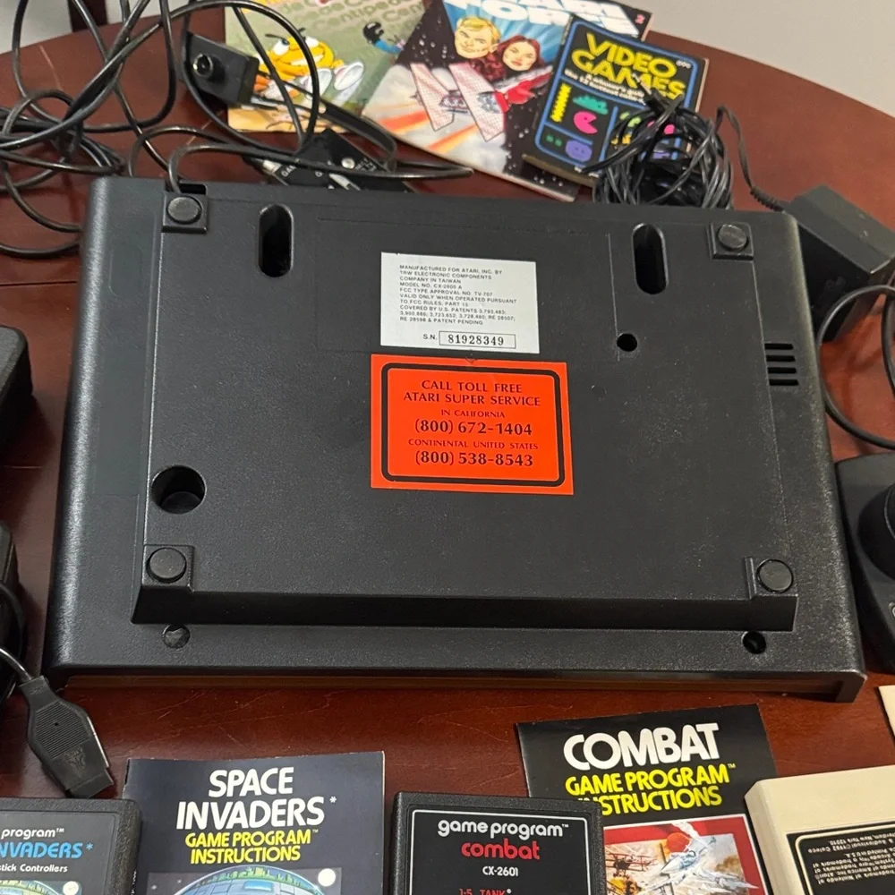 Vintage Authentic Atari 2600 with controllers, games and instruction booklets.